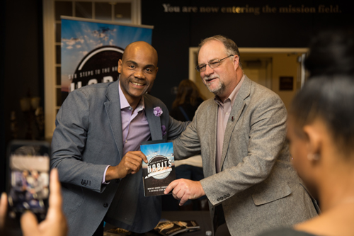 Dr. Goodloe and Dr. Mike Williams posing with a copy of Dr. Goodloe's HABITS book