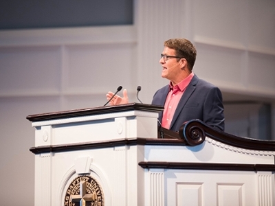 Mike Taylor, Executive Director of UK-USA Ministries, addresses students in the conference