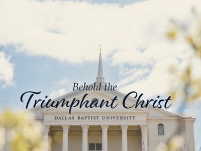 Behold the Triumphant Christ. The background shows the back of the DBU Chapel on a sunny day.